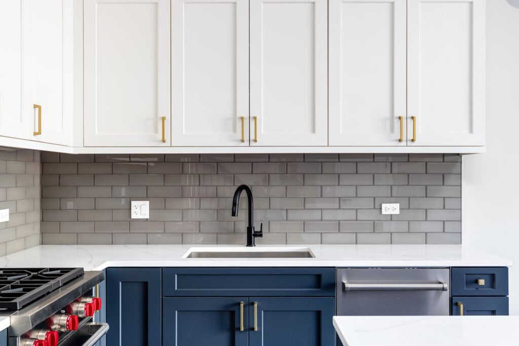 Detail shot of a kitchen with blue and white cabinets.